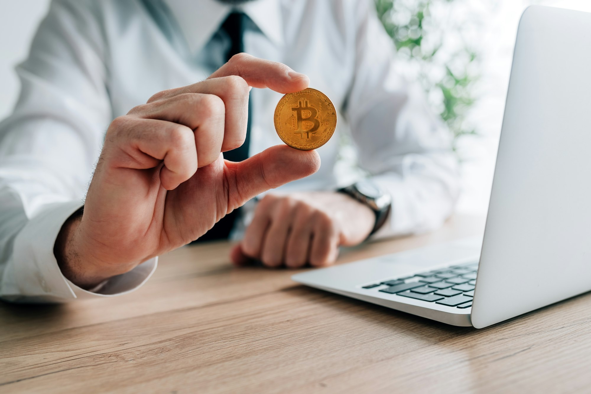 Bitcoin cryptocurrency investor concept, businessman offering one crypto currency coin