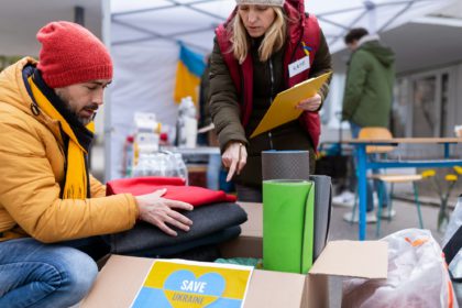 Volunteers distributing blankets and other donations to refugees on the Ukrainian border