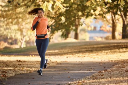 Young athletic woman running during sports training in the park.